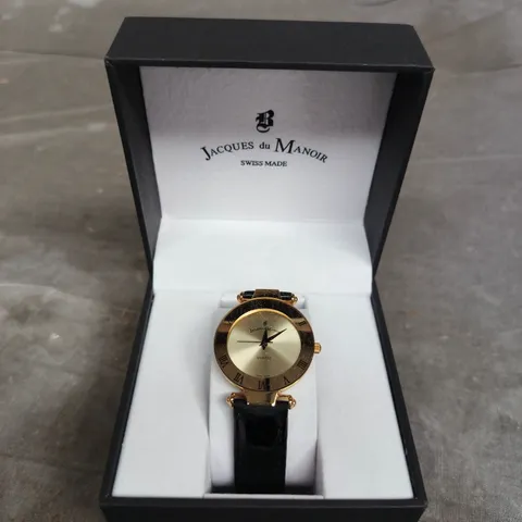 JACQUES DU MANOIR SWISS MADE QUARTZ WRISTWATCH – GOLD-TONE CASE, BLACK LEATHER STRAP