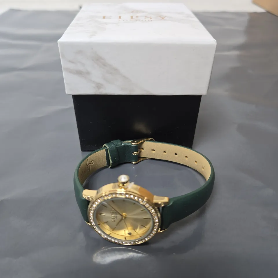 LIPSY LONDON WRISTWATCH – GOLD-TONE CASE, DIAMANTÉ BEZEL, GREEN STRAP