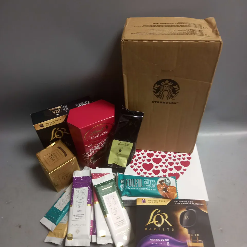 TOTE OF APPROX 12 ASSORTED FOOD ITEMS TO INCLUDE - STARBUCKS NESPRESSO COFFEE CAPSULES - PURE HEAVENLY CHOCOLATE BARS - LINDT MILK CHOCOLATE ETC