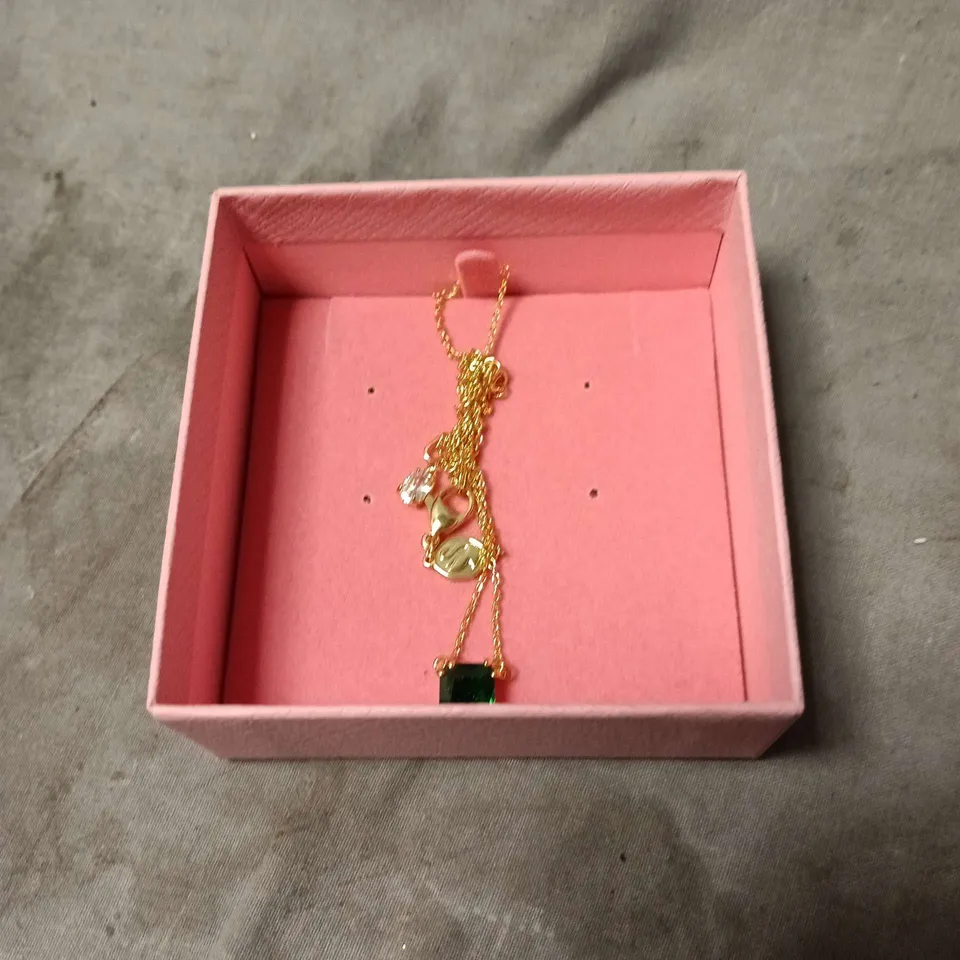 SWAROVSKI GOLD-TONE CHARM BRACELET WITH GREEN STONE – PINK PRESENTATION BOX 