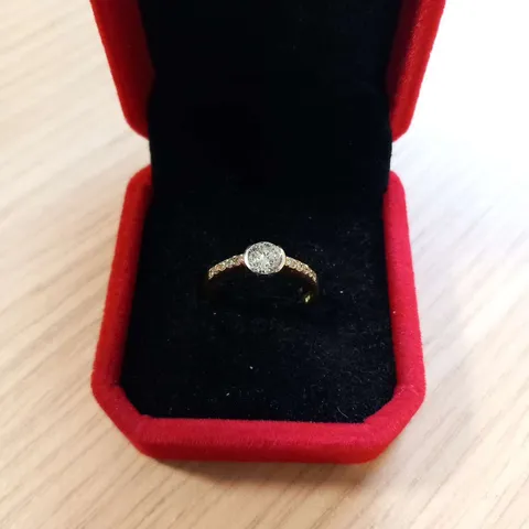 18CT GOLD RING SEMI RUB OVER SET WITH A NATURAL DIAMOND AND NATURAL DIAMONDS TO EACH SHOULDER