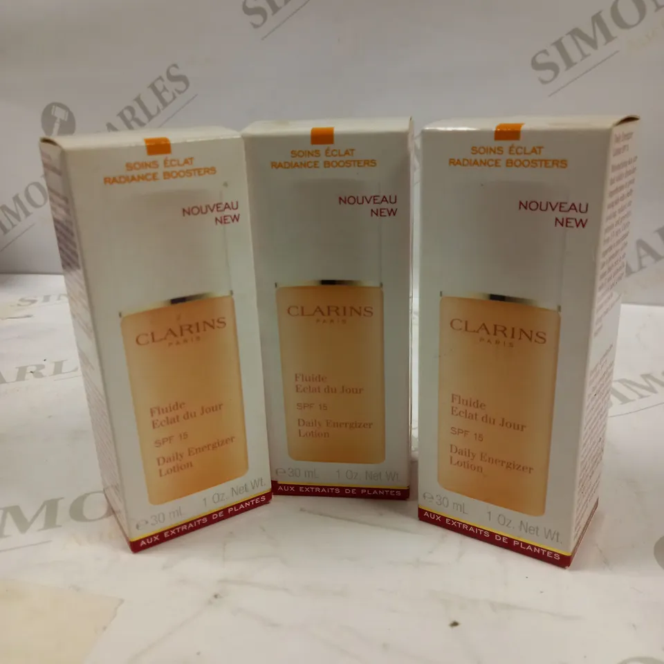 LOT OF APPROX 12 CLARINS PARIS DAILY ENERGIZER LOTION SPF 15 12 X 30ML