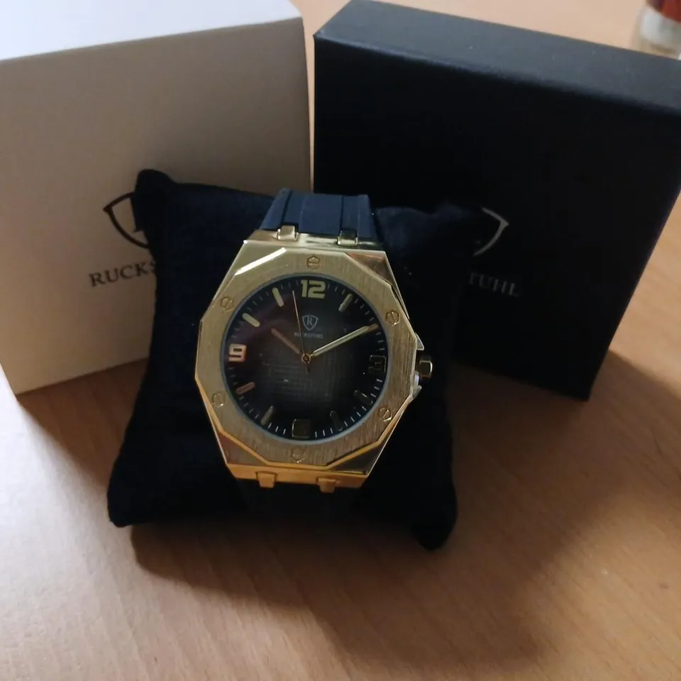 RUCKSTUHL GOLD-TONE WRISTWATCH WITH BLACK DIAL 