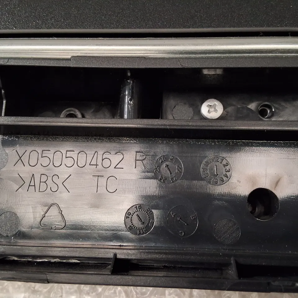 Black plastic chassis/slot component (Model WZXX90-BE B001-000) – likely peripheral