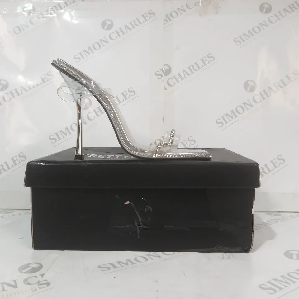 BOXED PAIR OF PRETTY LITTLE THING WIDE FIT OPEN SQUARE TOE STRAP HIGH HEEL SHOES IN METALLIC SILVER W. JEWEL EFFECT SIZE 6