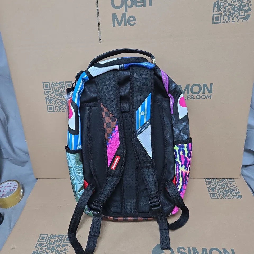 SPRAYGROUND LONDON FASHION WEEK BACKPACK – MULTICOLOURED GRAPHIC DESIGN WITH TAGS