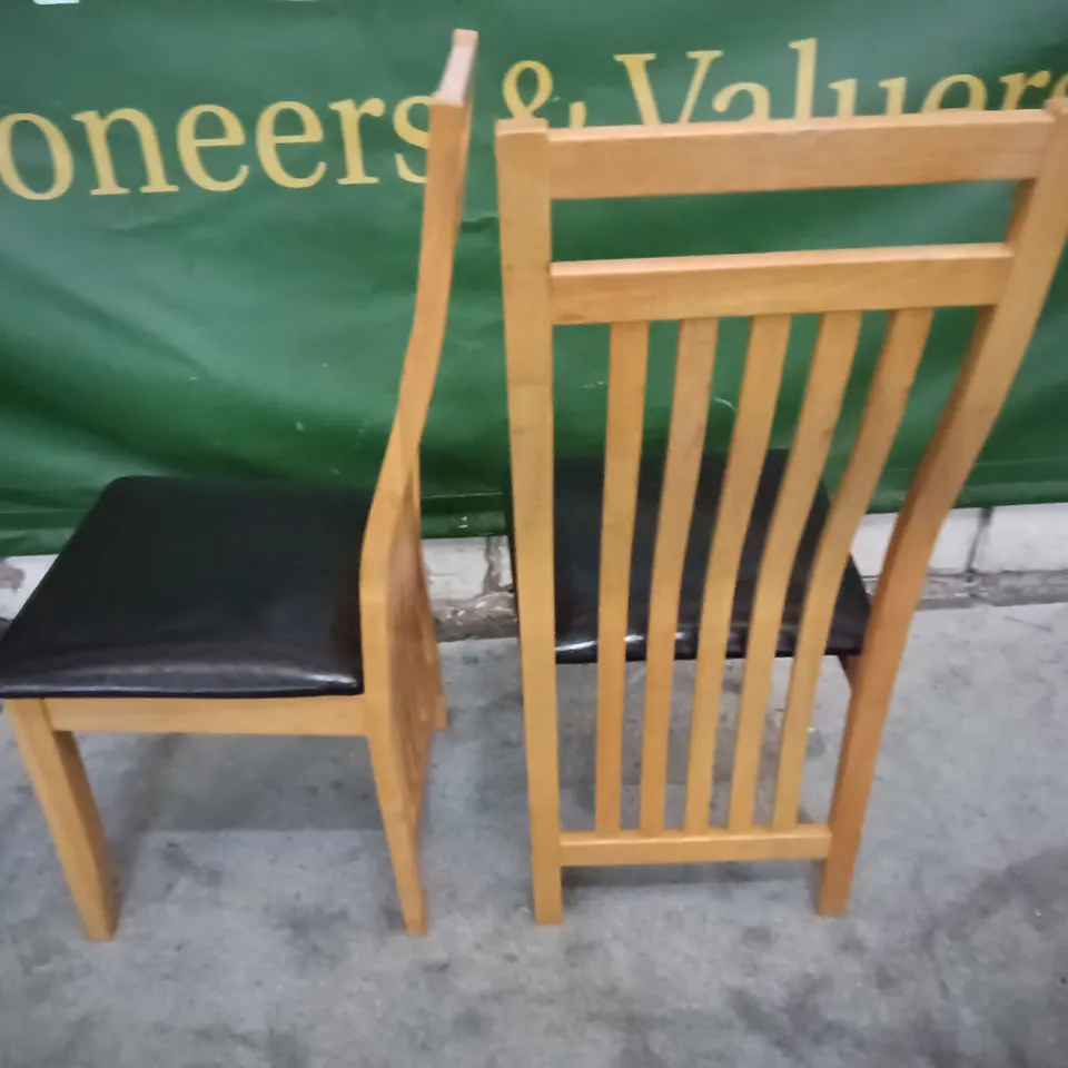 PAIR OF WOODEN DINING CHAIRS WITH BLACK FAUX LEATHER SEAT PADS 