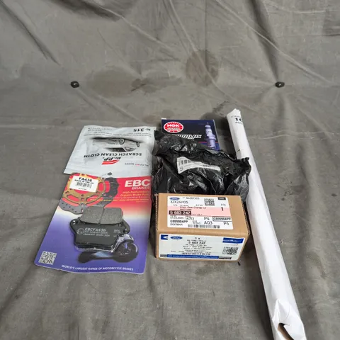 TOTE OF APPROXIMATELY. 15 ASSORTED CAR ITEMS TO INCLUDE BRAKE PADS , CLEAN CLOTHS , SPARK PLUGS AND TOOLS
