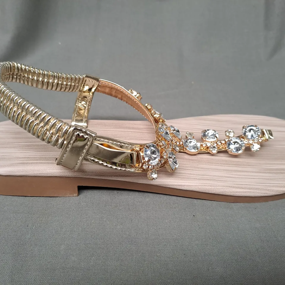 BOXED PAIR OF DESIGNER TOE-POST SANDALS IN METALLIC GOLD W. JEWEL EFFECT EU SIZE 41