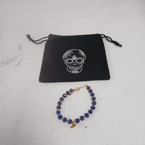 BLUE BEAD BRACELET WITH GOLD-TONE CLASP, WITH SKULL-PRINT POUCH