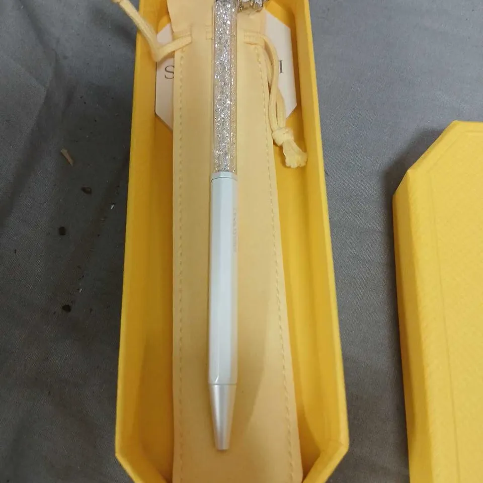 SWAROVSKI LIGHT BLUE PEN WITH GLITTERY SILVER CAP AND STAR CHARM IN YELLOW PRESENTATION BOX