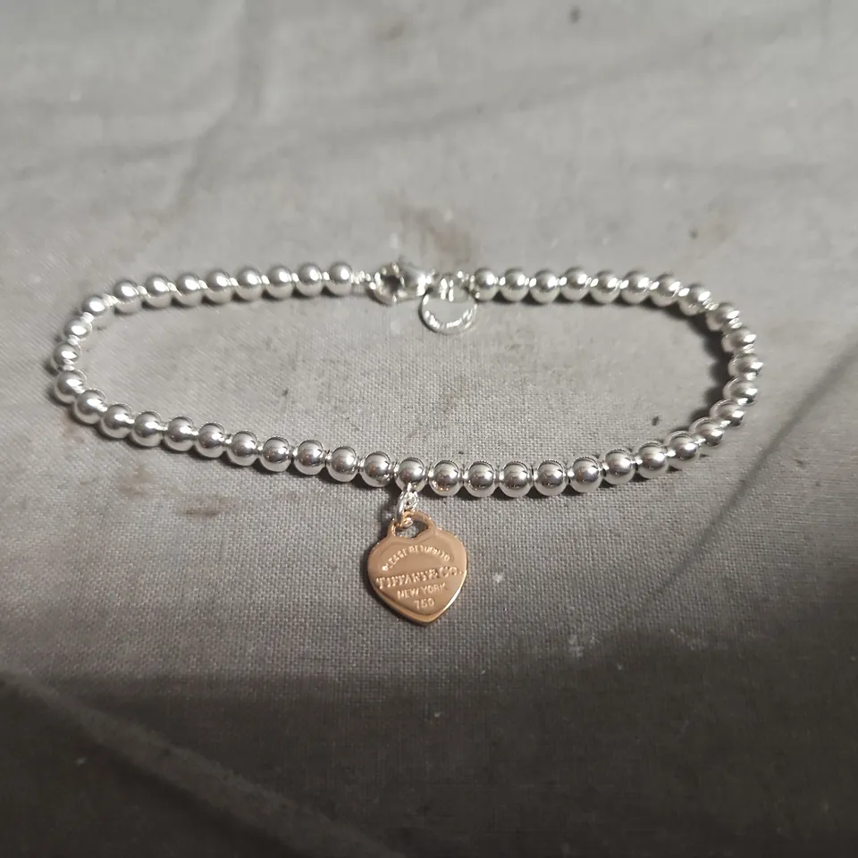 TIFFANY & CO SILVER-TONE BEAD BRACELET WITH COPPER HEART PENDANT