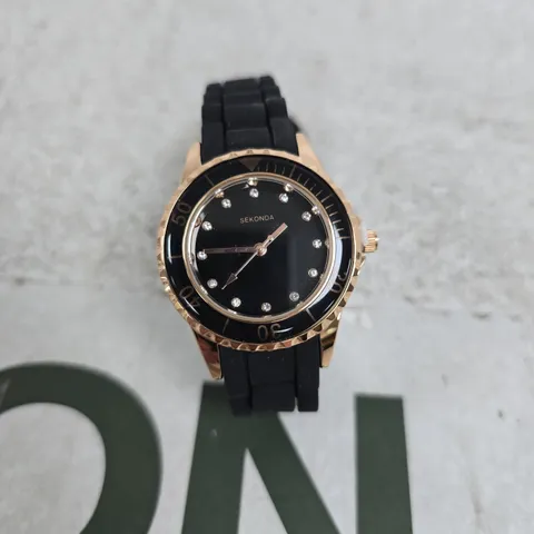 SEKONDA LADIES' BLACK DIAL WATCH WITH ROSE-GOLD TONE BEZEL AND BLACK RUBBER STRAP BOXED