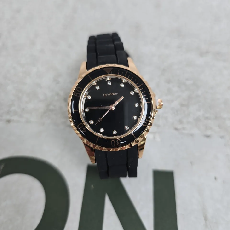SEKONDA LADIES' BLACK DIAL WATCH WITH ROSE-GOLD TONE BEZEL AND BLACK RUBBER STRAP BOXED