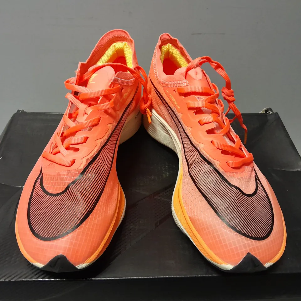 BOXED PAIR OF NIKE WOMENS ZOOMX VAPORFLY NEXT% TRAINERS IN ORANGE/WHITE - UK 5.5