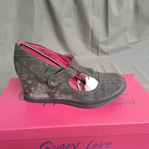 BOX OF APPROXIMATELY 10 PAIRS OF BLACK GUPPY LOVE WEDGE SHOES IN VARIOUS SIZES