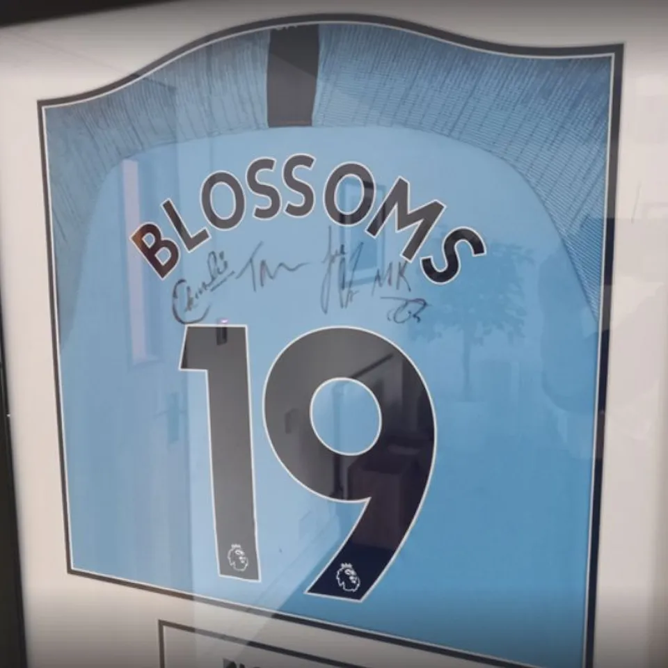 FRAMED AND MOUNTED MANCHESTER CITY SHIRT SIGNED BY STOCKPORT BASED BAND BLOSSOMS- ALL PROCEEDS WILL GO DIRECTLY TO CHARITY 