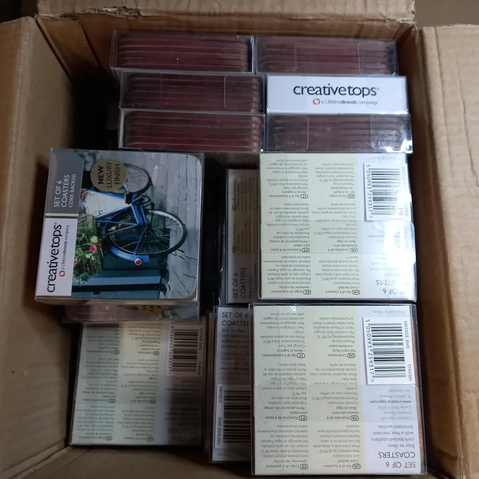 BOX OF APPROXIMATELY 50 CREATIVE TOPS SET OF 6 CORK BACK COASTERS IN A VINTAGE BICYCLE DESIGN