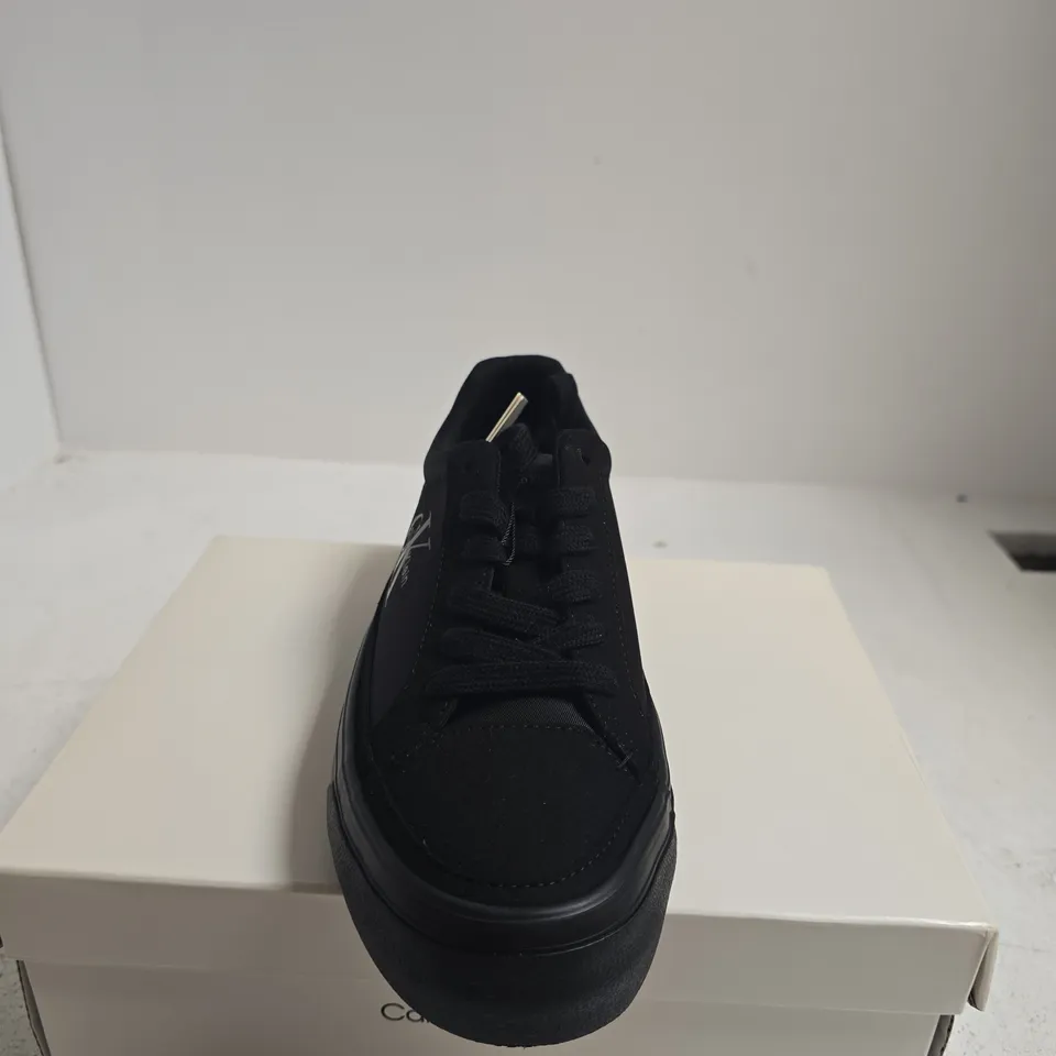 BOXED PAIR OF CALVIN KLEIN BLACK VULC FLAT LACE-UP SNEAKERS – UK5