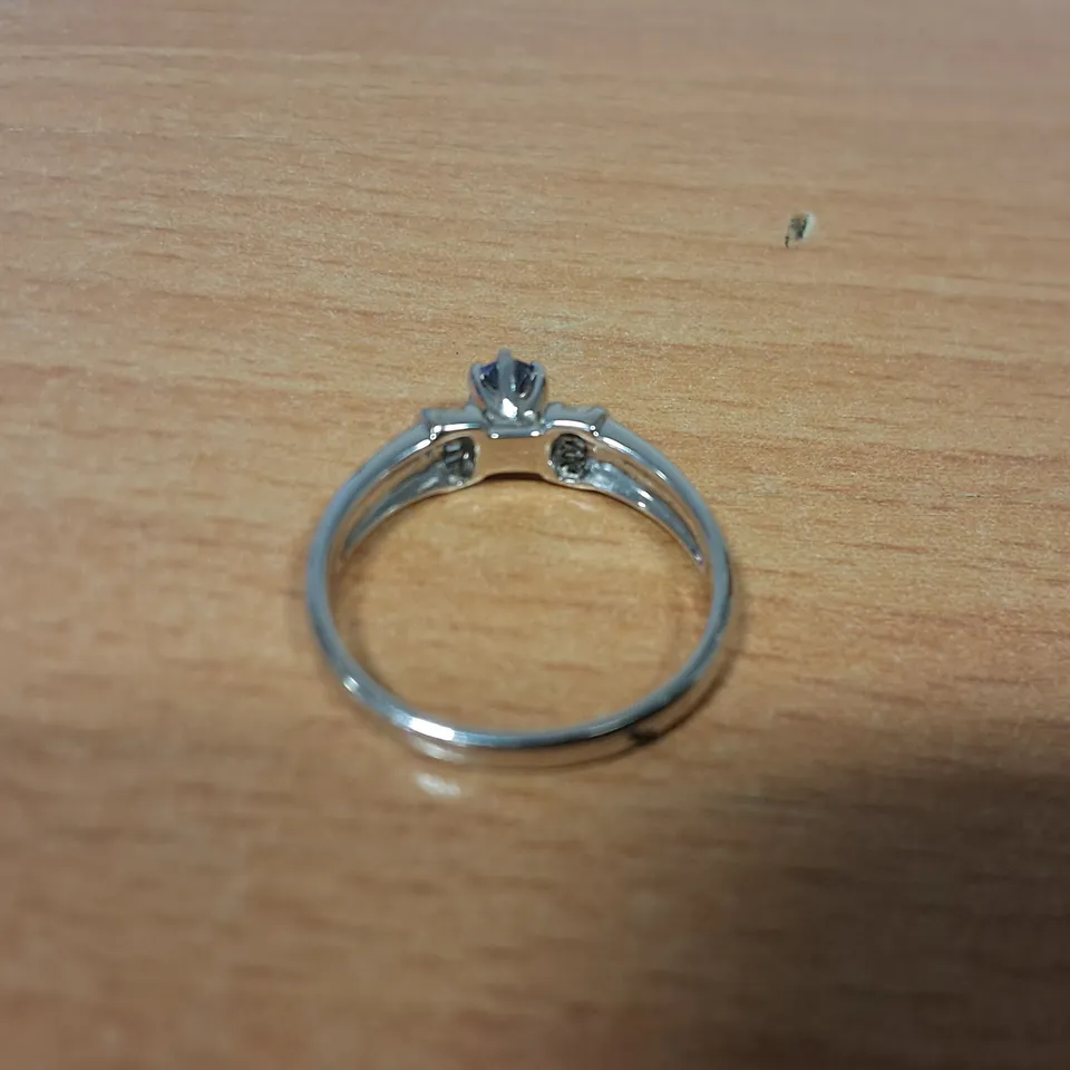 18CT WHITE GOLD RING SET WITH A TANZANITE AND NATURAL BAGUETTE CUT DIAMOND