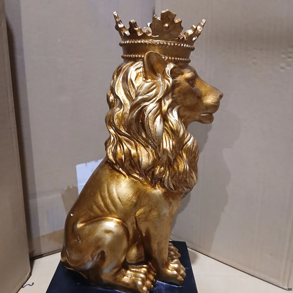 TWO GISELA GRAHAN GOLD-TONE LION ORNAMENT WITH CROWN ON DARK BASE