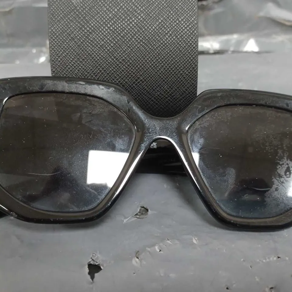 PRADA IRREGULAR SUNGLASSES IN BLACK