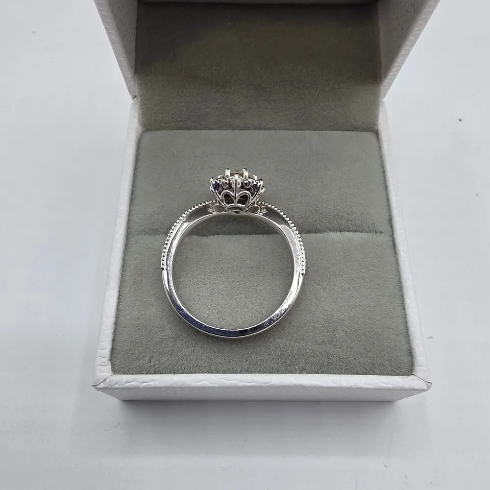 18CT WHITE GOLD RING SET WITH A NATURAL DIAMOND TO NATURAL DIAMOND HALO