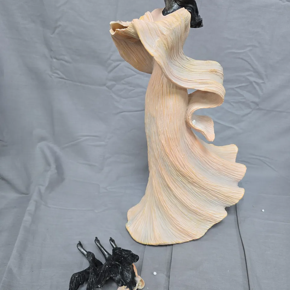 SCULPTURE OF A WOMAN IN A FLOWING GOWN