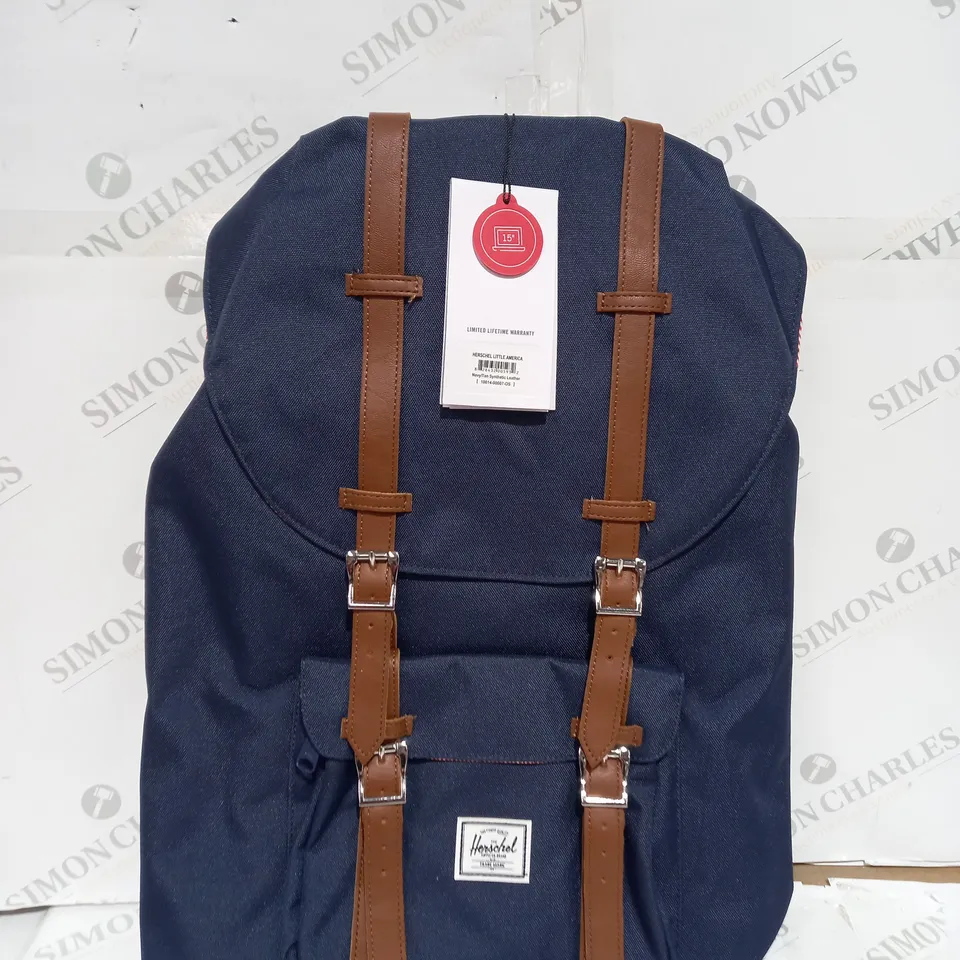 NAVY HERSCHEL RETREAT BACKPACK WITH BROWN STRAPS AND FOLD OVER TOP