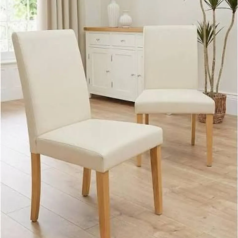 BOXED PRIMO PAIR OF FAUX LEATHER DINING CHAIRS - CREAM/OAK (1 BOX)