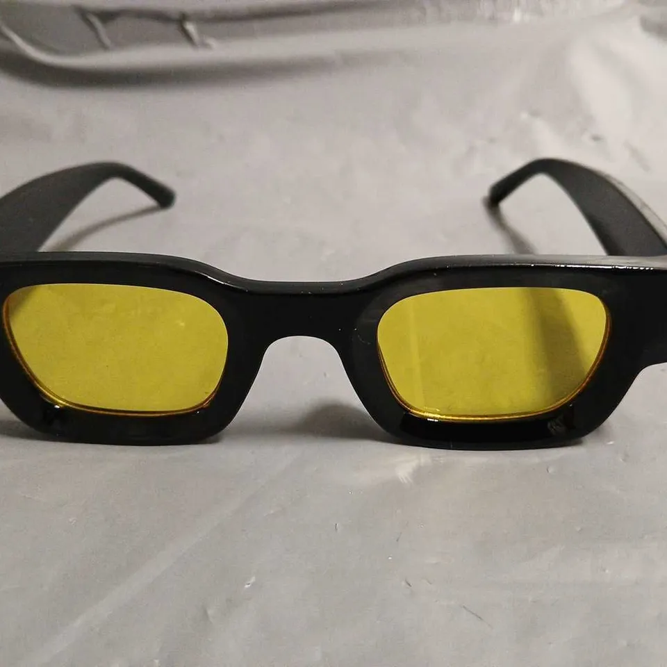 BOXED PAIR OF EYEKONIK BLACK FRAMED GLASSES WITH YELLOW TINT LENS