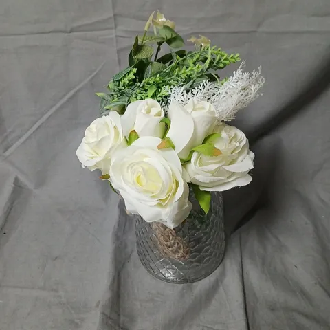 Artificial white rose floral arrangement in a textured glass vase
