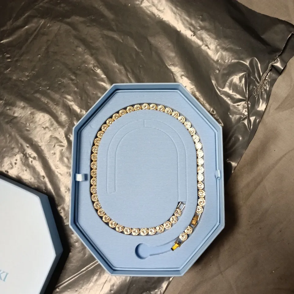 SWAROVSKI CRYSTAL TENNIS BRACELET IN GOLD-TONE SETTING – BOXED