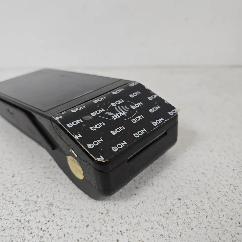 BLACK HANDHELD CARD MACHINE – APPEARS TO BE A DOCKING CRADLE OR ADAPTER