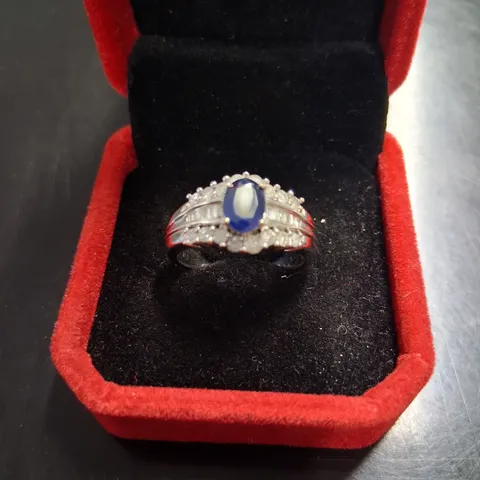 9CT WHITE GOLD DRESS RING SET WITH AN OVAL CUT SAPPHIRE AND NATURAL DIAMONDS WEIGHING +1.30CT