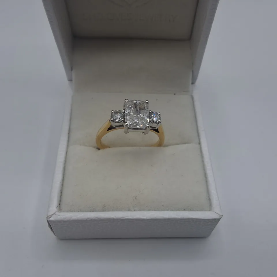 18CT RING SET WITH A NATURAL RADIANT CUT DIAMOND AND A NATURAL DIAMOND TO EACH SHOULDER WEIGHING +-2.46CT