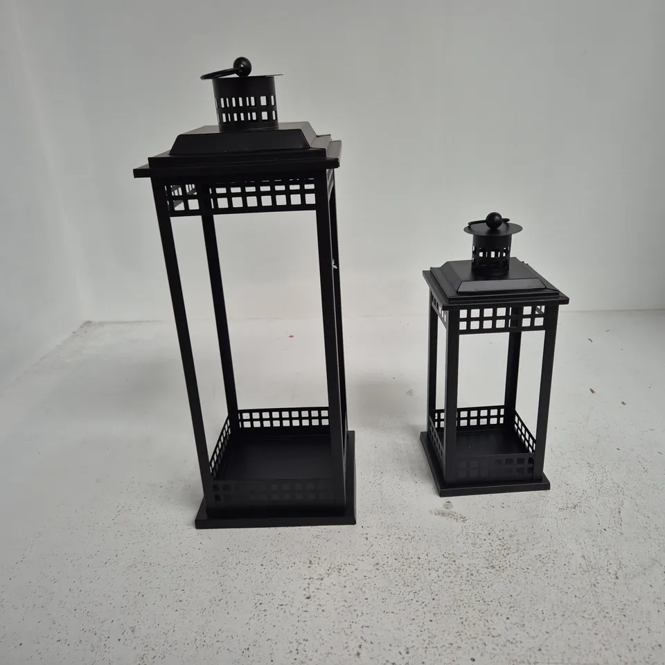TWO BLACK METAL GARDEN LANTERNS WITH LATTICE PANELS - TALL AND SHORT