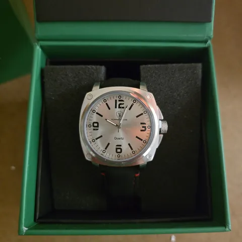 SCHWARTZBAUER WRISTWATCH – SILVER-TONE QUARTZ MOVEMENT, BLACK STRAP WITH RED STITCHING, IN GREEN PRESENTATION BOX