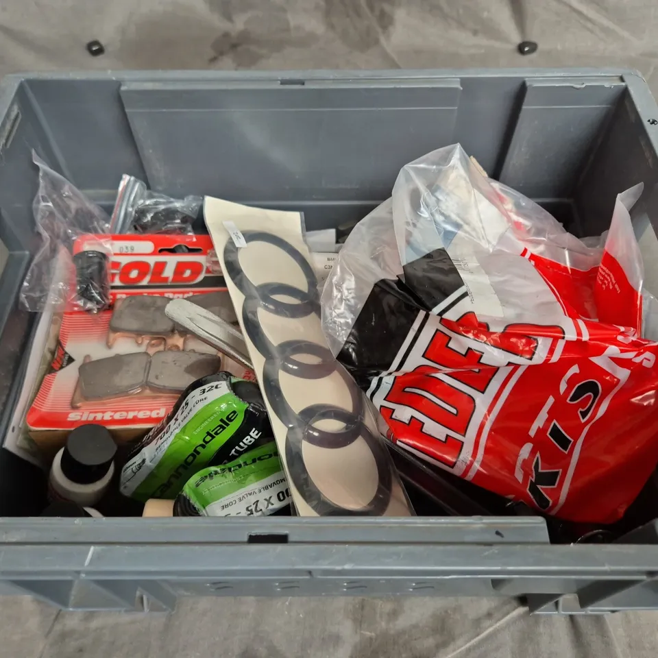 TOTE OF ASSORTED CAR ITEMS TO INCLUDE CAR BADGES , BRAKE PADS AND ACRYLIC PAINT 