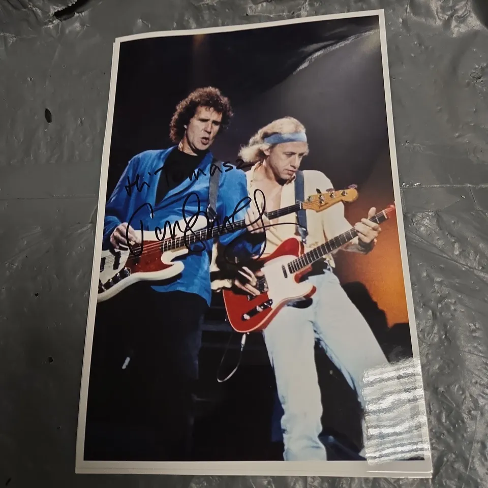 SET OF 4 AUTOGRAPHED ROCK PHOTOGRAPHS (SIGNED BY MARK KNOPFLER)