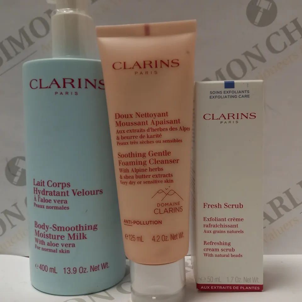 LOT OF 3 ASSORTED CLARINS PRODUCTS TO INCLUDE MOISTURE MILK, FOAMING CLEANSER, REFRESHING CREAM SCRUB