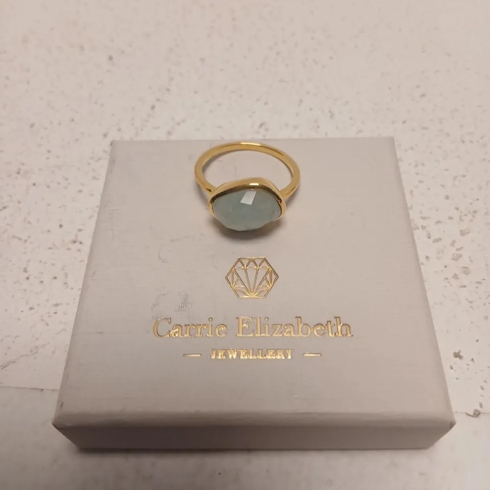 CARRIE ELIZABETH JEWELLERY GOLD-TONE RING WITH PALE BLUE GEMSTONE