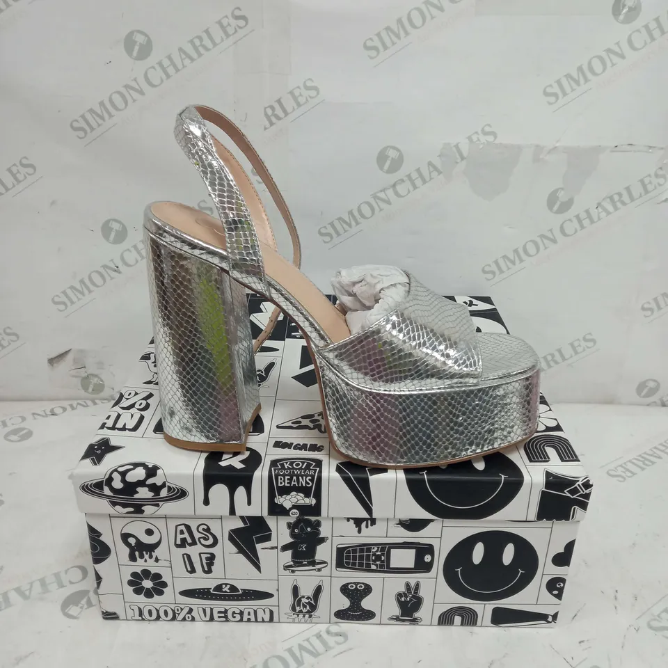 BOXED PAIR OF KOI FOOTWEAR STRAPPY PLATFORM HEELS IN SILVER - SIZE 8