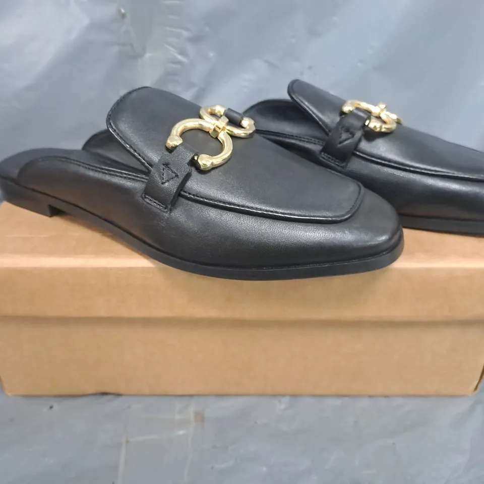 BOXED PAIR OF KAREN MILLEN OPEN BACK ELIP-ON LOAFERS IN BLACK W. GOLD EFFECT DETAIL SIZE 7