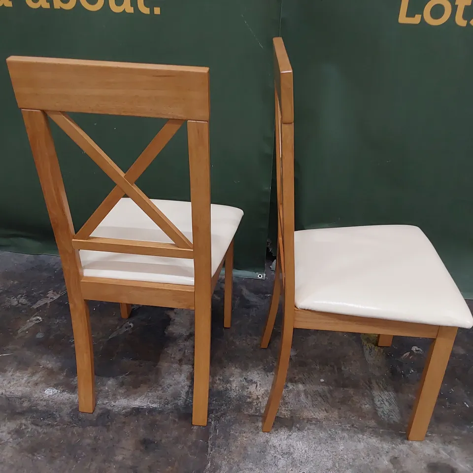 PAIR NATURAL WOOD FRAMED X BACK DINING CHAIRS CREAM PU SEATS