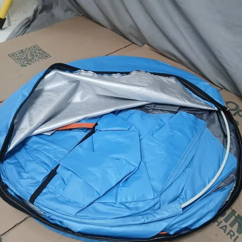 BLUE AUTOMATIC POP-UP CAMPING TENT IN ITS CARRYING BAG.