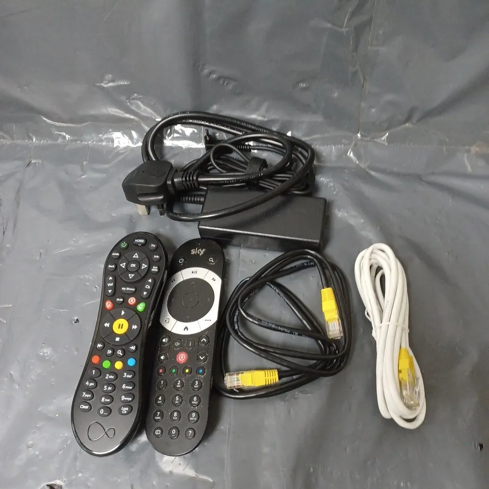 BOX OF APPROXIMATELY 20 ASSORTED ELECTRICAL ITEMS TO INCLUDE CABLES, REMOTE CONTROLS AND PLUGS