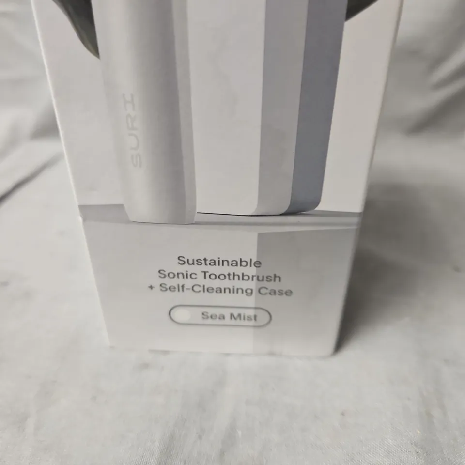 BOXED AND SEALED SURI SUSTAINABLE SONIC TOOTHBRUSH + SELF-CLEANING CASE – SEA MIST