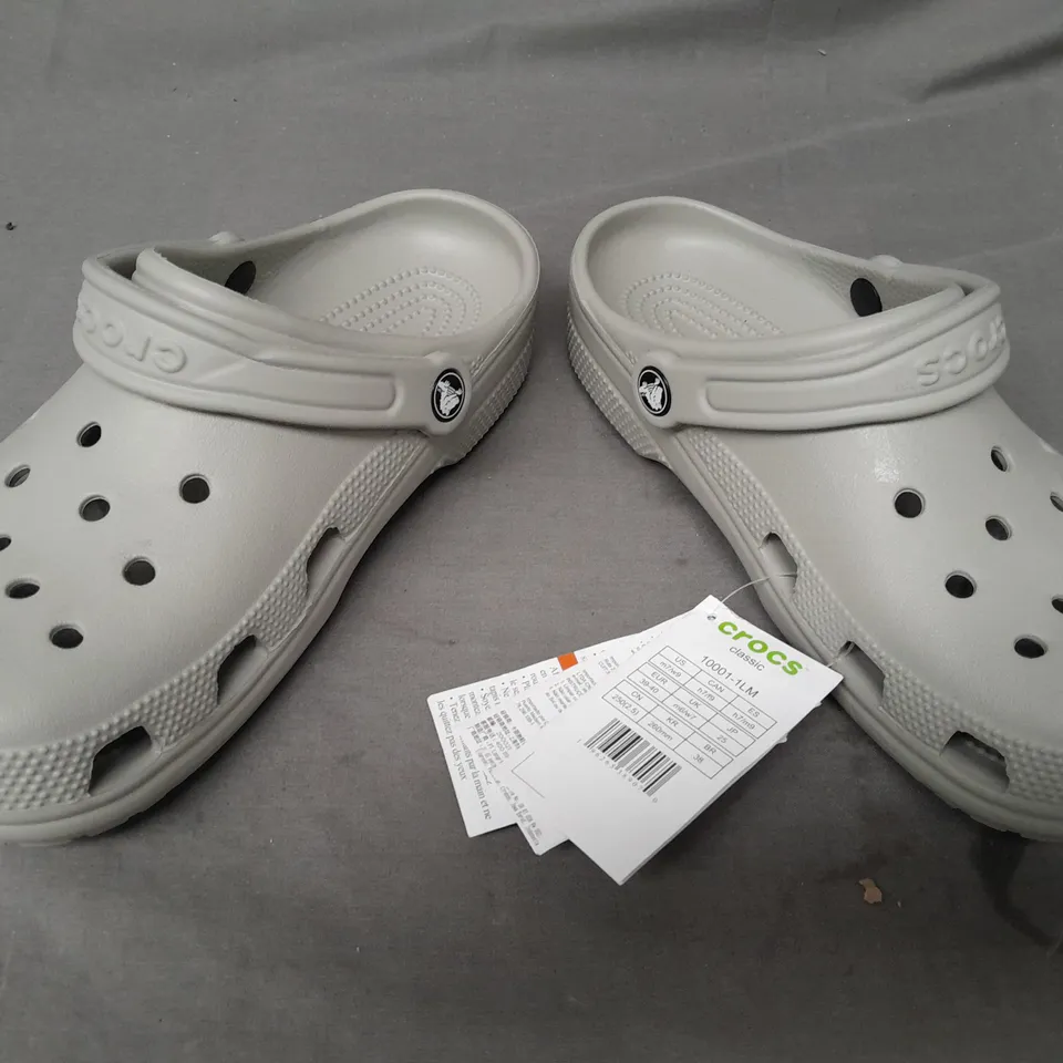 PAIR OF CROCS CLASSICS IN GREY UK SIZE M6/W7