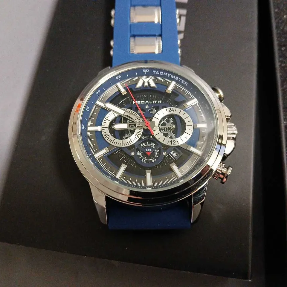 BOXED MEGALITH SKELETON FACED GENTS WATCH WITH STAINLESS STEEL BACK AND BLUE RUBBER STRAP